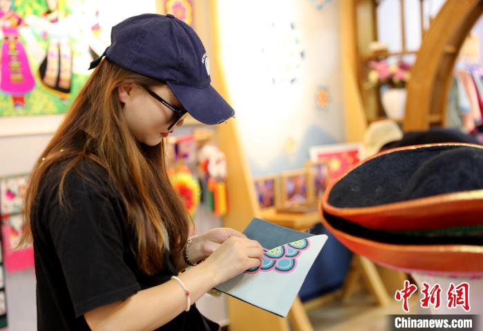 圖為民眾體驗(yàn)國家級(jí)非遺項(xiàng)目盤繡技藝。　薛蒂 攝